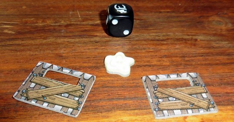 Le dé spécial Munchkin avec un 1 différent :), un jeton glu et 2 barricades pour renforcer le château !