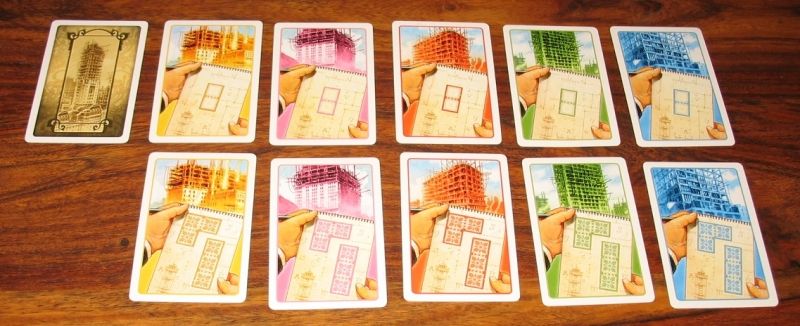 65 cartes terrains (de 2 ou 3 cases) en 5 couleurs (pour chaque district)  correspondant à tous les terrains de New York.