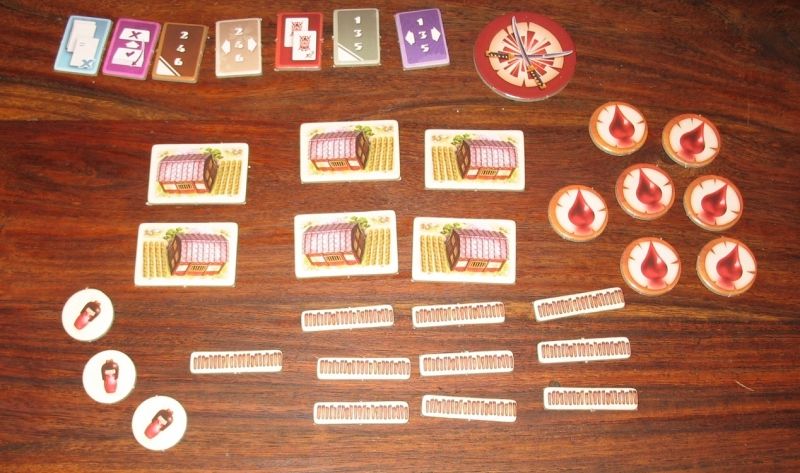 Des jetons pouvoirs (en haut), blessures (à droite), barrières (en bas), familles (en bas à gauche), fermes et un premier joueur.